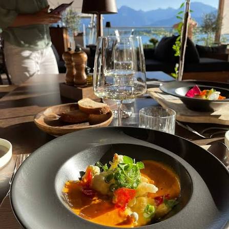 Plated regional dish at a restaurant overlooking the Alps