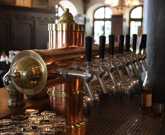 Historic polished copper beer taps in a Munich Wirtshaus