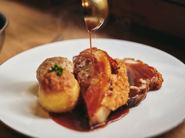 Bavarian roast with sauce being poured at the table